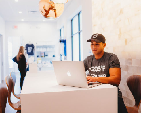 Man on laptop in front of Salt Wall.