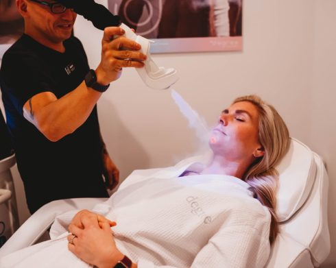 Woman receiving Cryotherapy Facial treatment on chin.