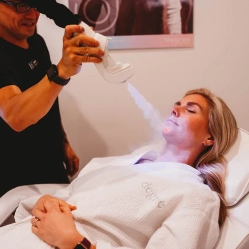 Woman receiving Cryotherapy Facial treatment on chin.