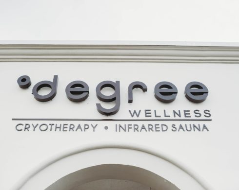 A close up of a Degree Wellness sign.