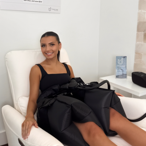 Female getting a compression massage for her hips after a workout at Degree Wellness