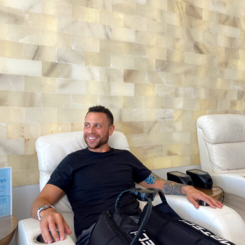 Male getting a compression massage for his legs after running at Degree Wellness