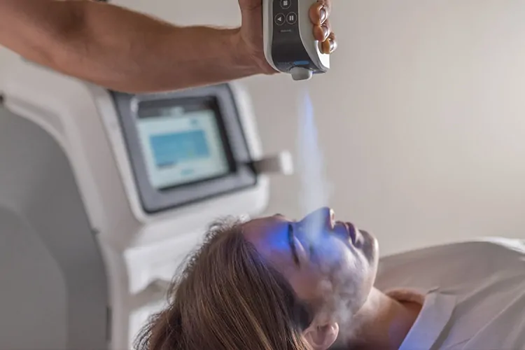 Man lying down receiving Cryotherapy Facial treatment.